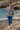 Female model wearing the sweatshirt with blue joggers