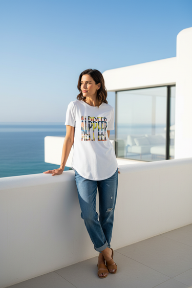 Female model wearing white graphic tee and distressed blue jeans