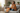 Female model wrapped in blanket on couch