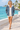Female promenade look with open windbreaker and ivory shorts