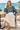 Female seaside café look with an ivory pleated skirt
