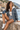 Female seated seaside look with denim shorts