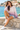 Female seated seaside look with denim shorts