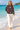 Floral bomber with linen trousers on the beach