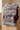 Folded burgundy sweater on travertine