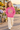 Four-year-old girl in raspberry hoodie at a coastal flower market