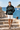 Geometric hoodie with off-white boardshorts by the harbor
