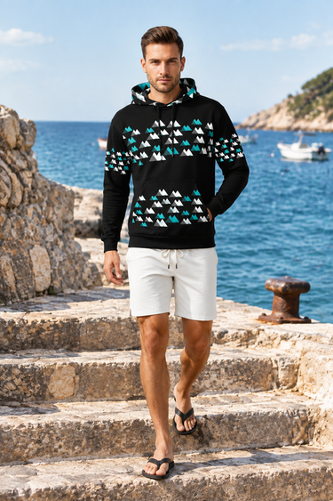 Geometric hoodie with off-white boardshorts by the harbor