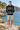 Geometric hoodie with sand boardshorts at a rocky cove