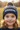 Girl age 4 wearing grey and navy beanie