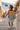 Girl in blue dress on village steps