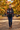Girl wearing the hoodie in an autumn park