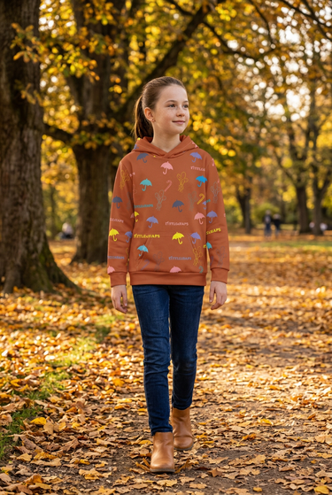 Girl wearing the rust hoodie in an autumn park