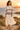 Golden-hour look with ivory pleated skirt