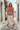 Hoodie styled with a cream midi skirt