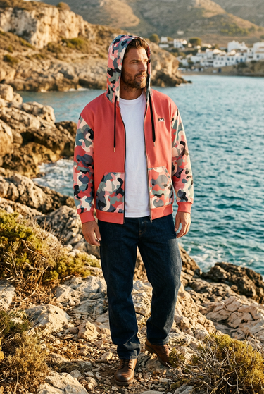 Hoodie styled with dark denim on a rocky coastline