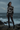Full-length female model wearing the botanical all-over-print sweatshirt with espresso leggings at a coastal overlook