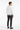 Back view of paint splash cardigan with dark chinos