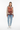 Abstract art sweater styled casually with light wash denim and white sneakers