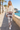 Ivory sweatshirt and leggings on a coastal promenade