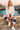 Ivory sweatshirt and striped joggers at a rocky cove