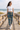 Joggers with white tee on coastal boardwalk