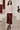 Knitted sweater styled with a burgundy satin skirt