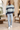 Male boutique hotel lounge look with light-wash jeans