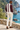 Male coastal back-view look with cream trousers