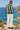 Male coastal back-view look with cream trousers