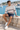 Male model in sweatshirt and navy chino shorts at the marina