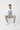 Male model in white crewneck with gray joggers sitting