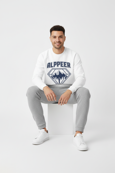 Male model in white crewneck with gray joggers sitting