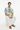 Male model in white linen pants and brown sandals