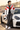 Male model leaning against a car in the paddock
