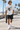 Male model wearing the ash skeleton skate tee on a beach boardwalk