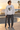 Male model wearing the ash sweatshirt beside a beachfront skate bowl