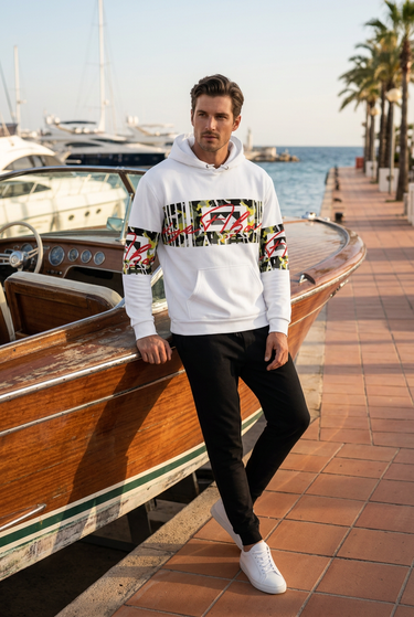 Male model wearing the hoodie with black joggers at a marina