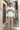 Male model wearing the hoodie with sand linen trousers