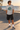 Male model wearing the sport-grey tee beside a beachfront skate bowl