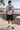 Male model wearing the sport-grey tee beside a beachfront skate bowl