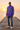Male model wearing the tie-dye sweatshirt with distressed blue jeans