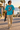 Male model wearing the tropical-blue tee in a surf town