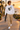Male model wearing the white sweatshirt in a surf town