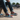 Man wearing colorful lace-ups on skateboard ramp with denim