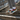 Man wearing colorful lace-ups with grey joggers on stairs
