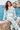 Matching hoodie and wide-leg joggers in the seated seaside look