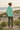Mint hoodie back view with olive cargo trousers