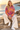 Model in tie-dye hoodie with cream linen trousers
