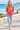 Model in tie-dye hoodie with jeans